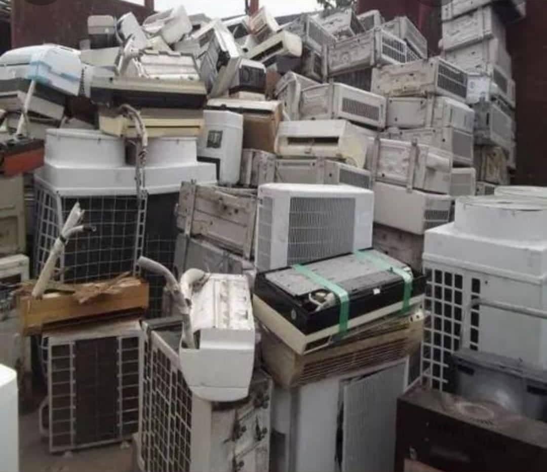 Old window and split air conditioners stacked together
